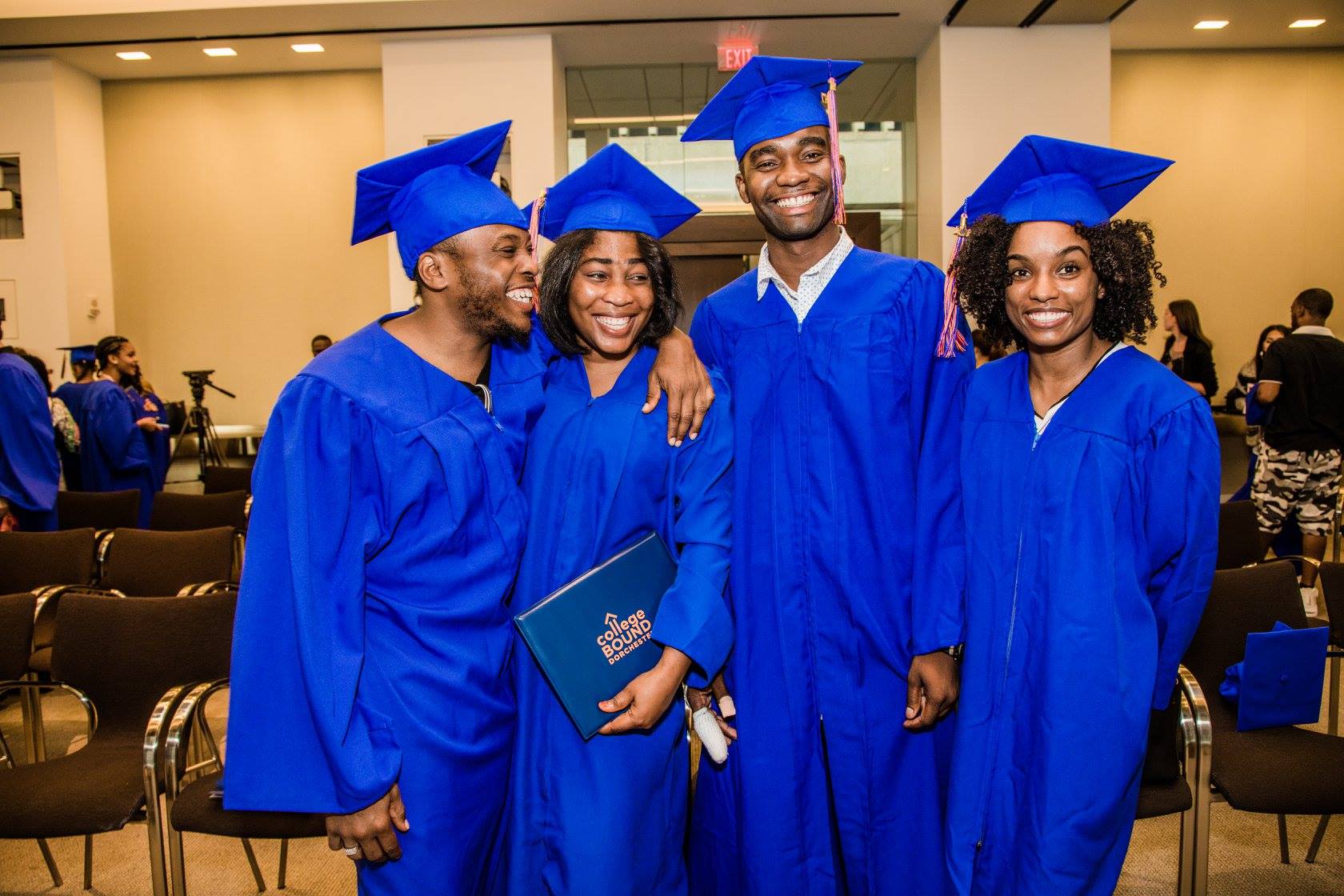 Four 2017 graduates of College Bound Dorchester wearing their caps and gowns